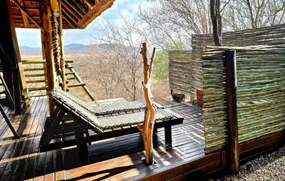 a bench on the deck of a cabin at Thulani in Doornfontein
