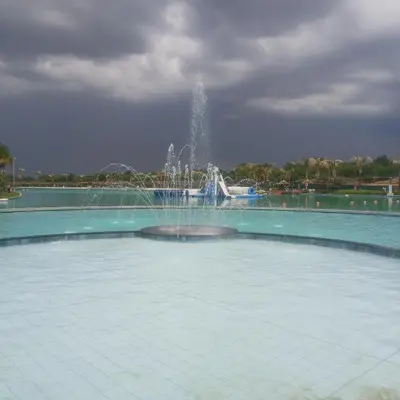 a fountain in the middle of a pool of water at The Blyde 1-Bed Luxe Apartment in Pretoria