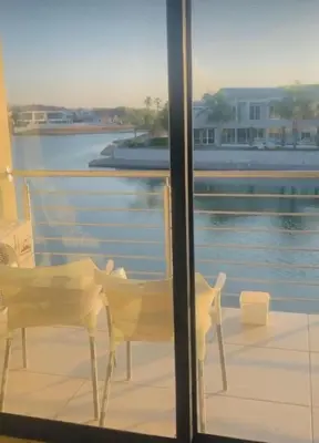 a balcony with two chairs and a view of the water at Lake Villa Hartebees in Hartbeespoort