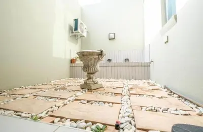 a room with a stone floor with a vase at Lake Villa Hartebees in Hartbeespoort