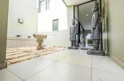 a room with statues on the floor of a building at Lake Villa Hartebees in Hartbeespoort