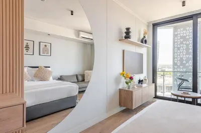 a living room with a couch and a tv at Cozy Stay at The Ellipse Waterfall in Midrand