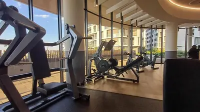 a gym with several tread machines in a building at Cozy Stay at The Ellipse Waterfall in Midrand