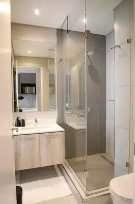 a bathroom with a shower and a sink and a toilet at 418 menlyn Maine trilogy in Pretoria