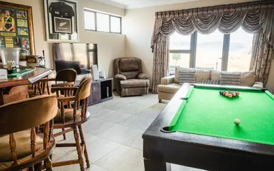 a living room with a pool table at Highland Gate Golf & Trout Estate, House 925 in Dullstroom
