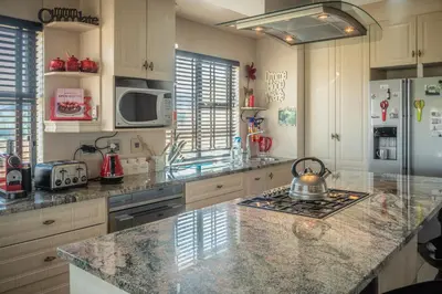 a kitchen with a counter with a tea kettle on a stove at Highland Gate Golf & Trout Estate, House 925 in Dullstroom
