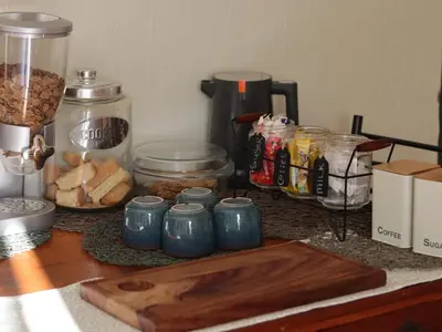 a counter top with a bunch of food and a blender at Karee Guesthouse in Thabazimbi