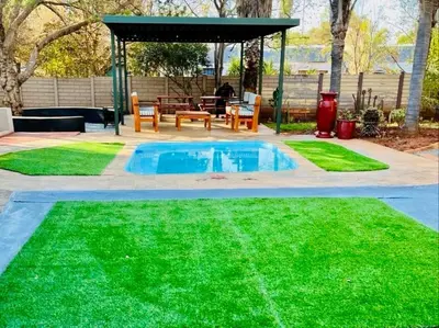 a backyard with a small pool and a gazebo at Karee Guesthouse in Thabazimbi