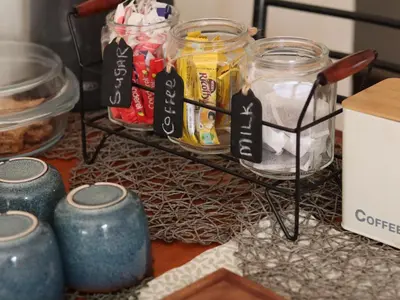 a shelf with jars of food on a table at Karee Guesthouse in Thabazimbi