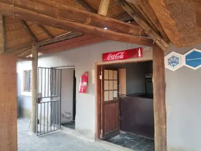 a coca cola sign on the side of a building at Jamrock Lodge in Winterveld