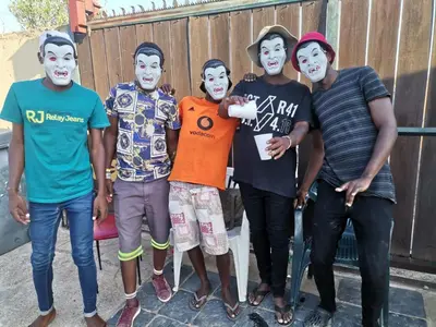 a group of people wearing face paint at Jamrock Lodge in Winterveld