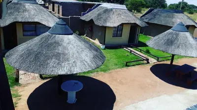 an aerial view of a house with umbrellas at Jamrock Lodge in Winterveld