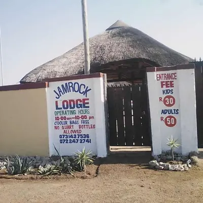 a small building with a sign in front of it at Jamrock Lodge in Winterveld