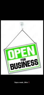 a sign that reads open for business hanging from a hook at Jamrock Lodge in Winterveld