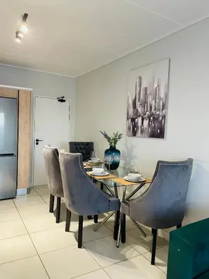 a dining room with a table and chairs at 2 Bedroom- The Blyde by Given in Pretoria
