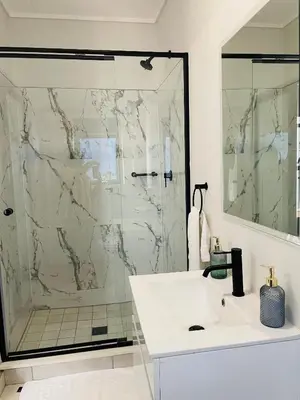a bathroom with a shower and a white sink at 2 Bedroom- The Blyde by Given in Pretoria