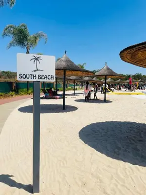 a sign on a beach with umbrellas at 2 Bedroom- The Blyde by Given in Pretoria