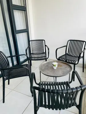 four black chairs and a table with a coffee table at 2 Bedroom- The Blyde by Given in Pretoria