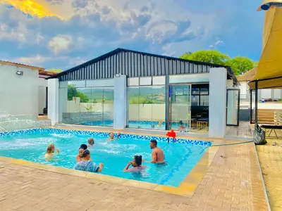 a group of people in a swimming pool at Shibar farm house Mpumalanga in eLundi