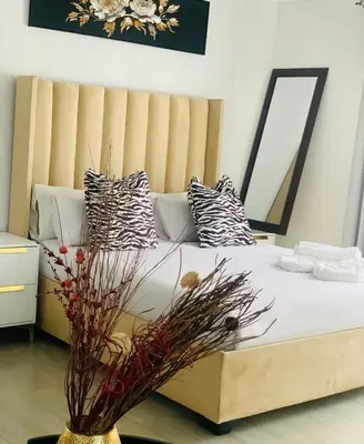 a bedroom with a bed with a vase with flowers on it at Shibar farm house Mpumalanga in eLundi