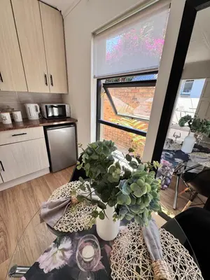 a kitchen with a table with a potted plant on it at Cozy Suburban Escape in Benoni