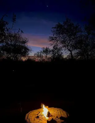 a fire is burning in a tire at night at Wabisabi the wild at your doorstep in Marloth Park