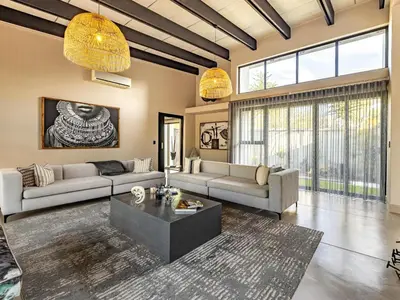a living room with two couches and a coffee table at Ingwenkala Luxury Safari Lodge - 5 Star in Hoedspruit