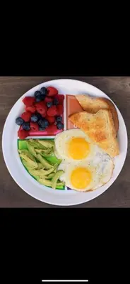 a plate of breakfast food with eggs avocado beans and toast at Ingwenkala Luxury Safari Lodge - 5 Star in Hoedspruit