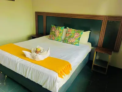 a bedroom with a bed with a white flower on it at Stay Inn Budget Rooms in Phalaborwa