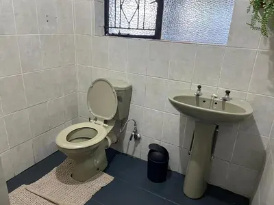 a bathroom with a toilet and a sink at Stay Inn Budget Rooms in Phalaborwa