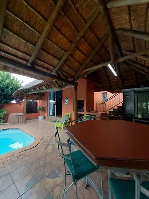 a ping pong table in a patio with a pool at Coral Suite in Pretoria
