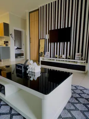 a living room with a table and a tv at Dimension 1 in Midrand