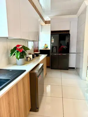 a kitchen with a refrigerator and a plant on the counter at Luxury Redefined Home in Middelburg