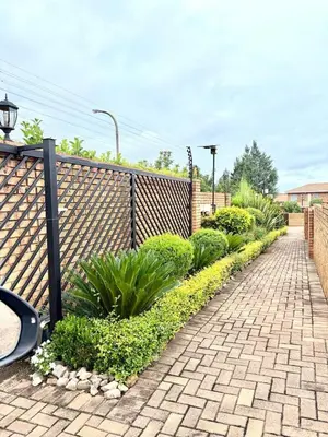a garden with plants and a fence at Luxury Redefined Home in Middelburg