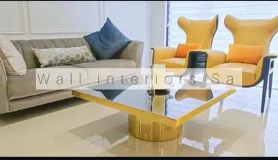 a living room with a couch and a glass coffee table at 2 bedroom luxury Ellipse waterfall in Midrand