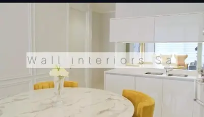 a white kitchen with a table with a vase of flowers on it at 2 bedroom luxury Ellipse waterfall in Midrand