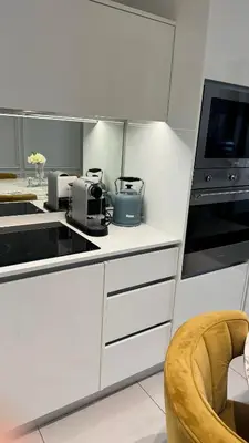 a kitchen with white cabinets and a counter top at 2 bedroom luxury Ellipse waterfall in Midrand