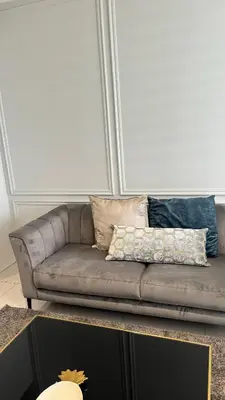 a couch with pillows on it in a living room at 2 bedroom luxury Ellipse waterfall in Midrand