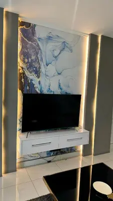 a flat screen tv on a wall in a living room at 2 bedroom luxury Ellipse waterfall in Midrand