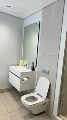 a white bathroom with a toilet and a sink at 2 bedroom luxury Ellipse waterfall in Midrand