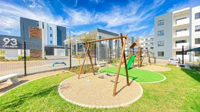 a playground with a swing set in a park at Binbin Serenity Suite in Midrand