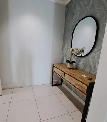 a dressing room with a mirror and a table at Ellipse Waterfall luxurious and modern apartment in Midrand