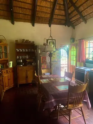 a kitchen with a table and chairs in a room at Hermit Hill in Broederstroom