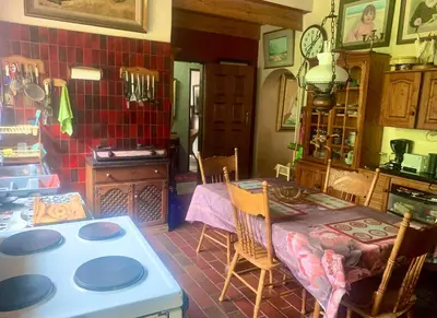 a kitchen with a table and a stove in a room at Hermit Hill in Broederstroom