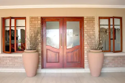 two large vases sitting in front of a door at The Finches Nest in Hammanskraal
