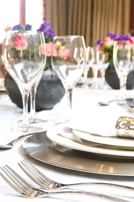 a table with plates and wine glasses on it at The Finches Nest in Hammanskraal