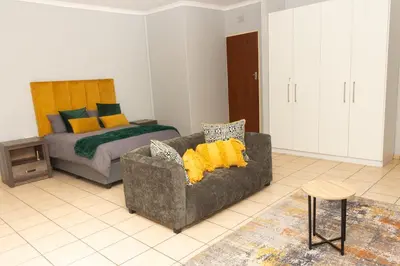 a living room with a couch and a bed at 22 Eland in Polokwane