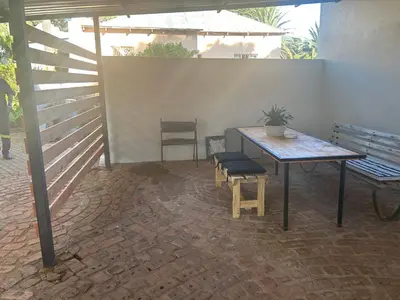 a patio with a table and a bench and a table at @144 Rabe in Mokopane