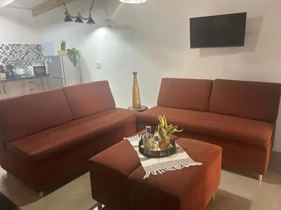 a living room with two brown couches and a table at @144 Rabe in Mokopane