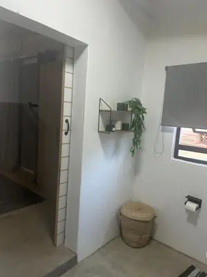 a hallway with a door and a plant on a wall at @144 Rabe in Mokopane